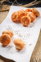 Multigrain mushroom buns on a white porcelain plate