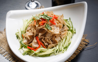 Cold oat noodle soup in a white porcelain plate