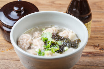Wonton soup in a green porcelain bowl
