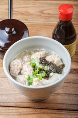 Wonton soup in a green porcelain bowl