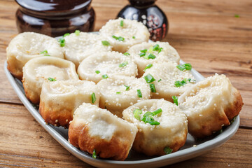 Shanghai style pan-fried buns on a porcelain plate