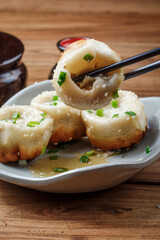 Shanghai style pan-fried buns on a porcelain plate