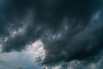 Dramatic dark storm thundercloud rain clouds on black sky background. Dark thunderstorm clouds...