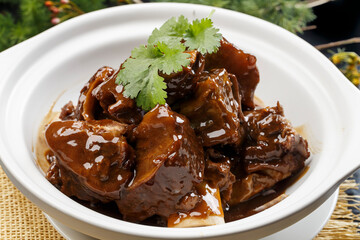 White casserole with fragrant sauce and oxtail bones