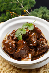 White casserole with fragrant sauce and oxtail bones