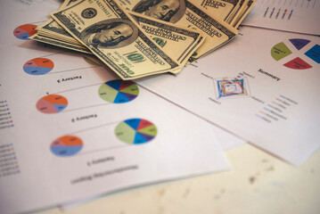 Office desk money bank note financial report business chart graph on wood table. Flat lay money...