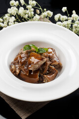 Delicious cold braised pig's trotters in a round white porcelain plate
