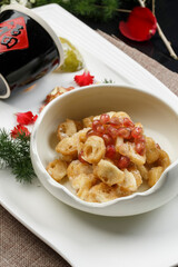Fried gluten with pomegranate seeds served in celadon tableware