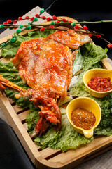 Mongolian barbecued lamb legs on wooden tray