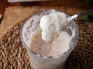 Bubbly sourdough starter in glass jar. Active yeast for bread making