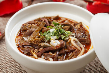Spicy lamb and potato noodles in a white porcelain bowl