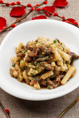 White porcelain plate with beef stewed with onion and potatoes