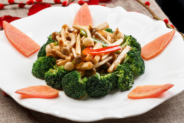Stir-fried broccoli with mushrooms on a white porcelain plate