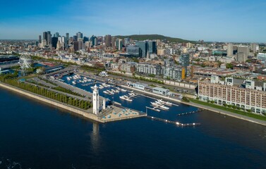 Aerial view of Montreal's Old Port in Canada, showcasing the iconic Clock Tower and marina filled...