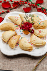 Yuanbao fried bean paste crisps on a white porcelain plate