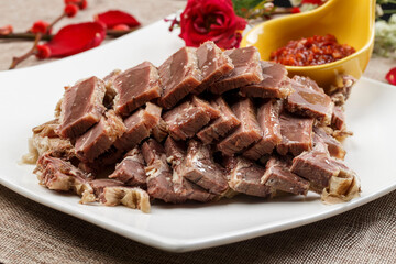 Crystal donkey meat on a white porcelain plate