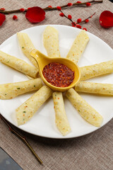 Tortilla chips with dipping sauce on a white porcelain plate