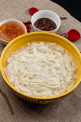 Boiled noodles in a yellow porcelain bowl