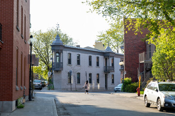 A woman crosses a quiet street inPlateau Montreal, Montreal, Quebec, Canada, on a sunny day. The...