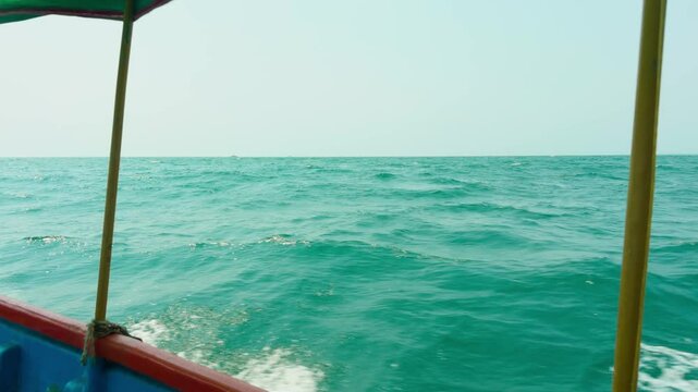 Sailboat moves gently across calm tropical expanse