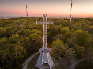 Mount Royal Cross in Montreal, Canada, illuminated at dusk. The cross stands as a symbol of the...