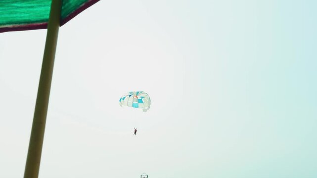 Parachute lifts tourist into clear skies