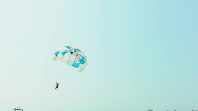 Summer vacationer enjoy vibrant parasail flight