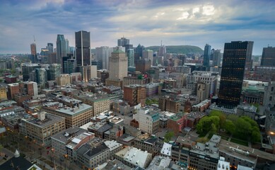 Montreal, Canada cityscape at dusk. Aerial view of the city's architecture, including skyscrapers and historic buildings, showcasing urban development and design.