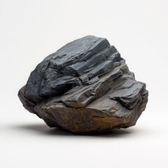Obraz premium A dark gray rock with layered texture, isolated on white background