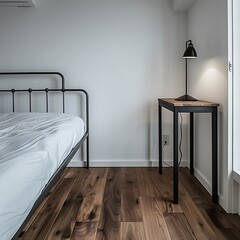 Serene minimalist bedroom interior featuring a simple bed and bedside lamp casting soft light