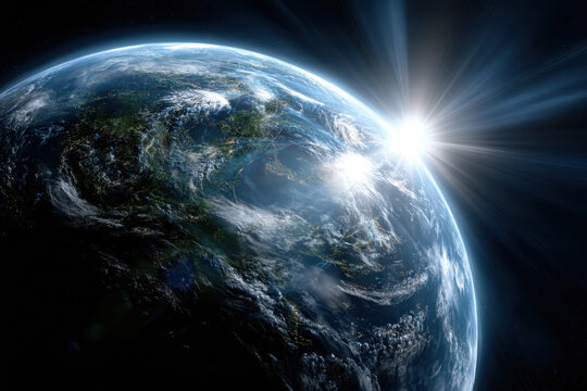 Sunlight breaking through clouds over Earth during sunrise from outer space view