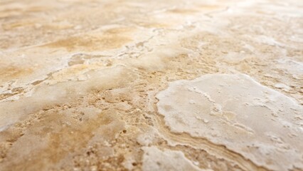 Closeup view of a luxurious beige and brown marble texture with swirling patterns and variations in color