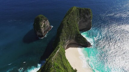 Scenic drone shot in leftward orbit around iconic T-Rex-shaped cliff at Kelingking Beach, Nusa Penida, Bali, captured in 2025 with clear weather and turquoise sea. - Powered by Adobe