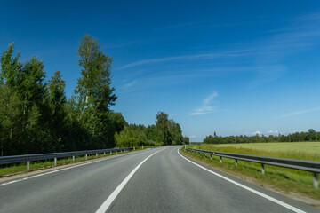 Scenic Drive Through Countryside with Clear Blue Sky and Asphalt Road – Rural Transportation Concept