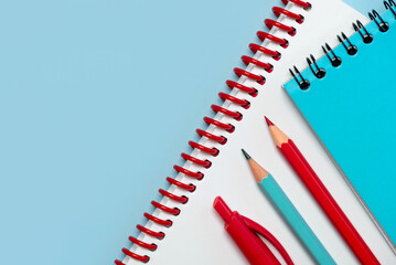 Top view of spiral notepads and school pencils and pen with space for text. Back to school concept