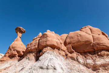 Fototapeta premium Entrada Sandstone（Middle Jurassic）with Dakota Formation. Toadstool Hoodoos Trail, Kane County, Utah geology. tent rock, fairy chimney, or earth pyramid. Weathering, erosion.