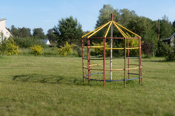 Classic Metal Climbing Frame in Outdoor Playground in Rural Green Space. Rusty Old Playground...
