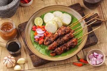 Sate Ayam. Chicken satay is a typical Indonesian food. Chicken satay is made from chicken meat. In general, chicken satay is cooked by grilling using charcoal and served with a choice of peanut sauce 