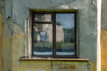 Old Weathered Window with Peeling Paint and Cracked Wall in Rustic Countryside Building