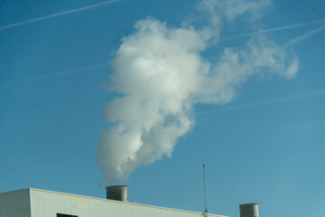 A large cloud of smoke is rising from a building