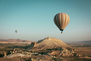 Hot air balloons drift freely across the picturesque Cappadocia landscape