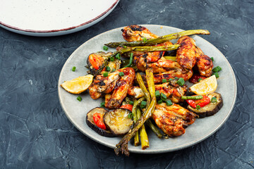 Plate of roast chicken wings, food photography.