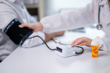 A doctor is taking a patient's blood pressure