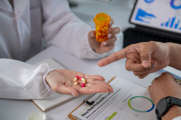 A doctor is holding a bottle of pills