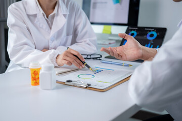 Two doctors are discussing a patient's medical condition