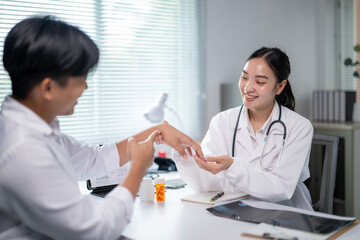 A woman doctor is talking to a man in a white shirt