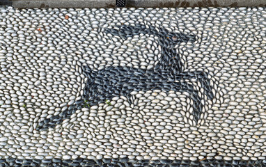 a finely arranged pebble floor, forming a decorative mosaic typical of the island of Rhodes, Greece.