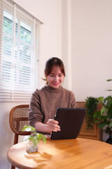 Asian Young Adult Woman Engaged with Tablet Device at Home Daily Lifestyle Digital Connectivity AI...