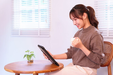 Asian Woman Optimizing Daily Life With AI Tablet Enhanced Digital Experiences And Connected Living...