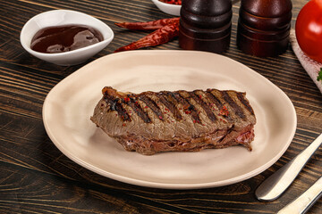 Grilled beef striploin steak with sauce